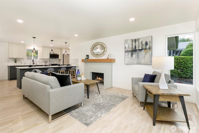 18733 50th Ave NE, Lake Forest Park, WA 98155 - living room with plenty of natural light, light wood-style floors, recessed lighting, a fireplace, and baseboards