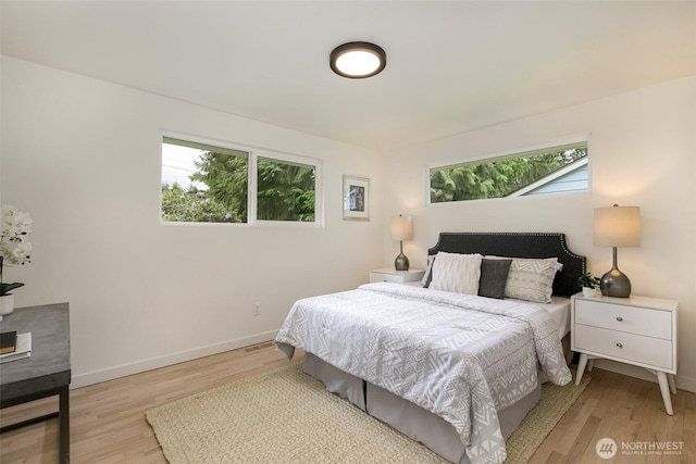18733 50th Ave NE, Lake Forest Park, WA 98155 - bedroom featuring multiple windows, light wood finished floors, and baseboards