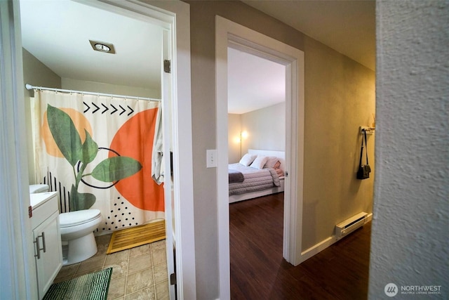 34012 1st Pl S # J, Federal Way, WA 98003 - full bathroom with vanity, wood finished floors, toilet, a baseboard heating unit, and a shower with curtain