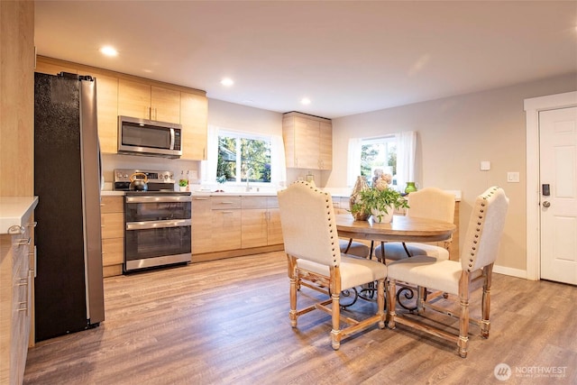 dining area with recessed lighting, baseboards, and light wood finished floors