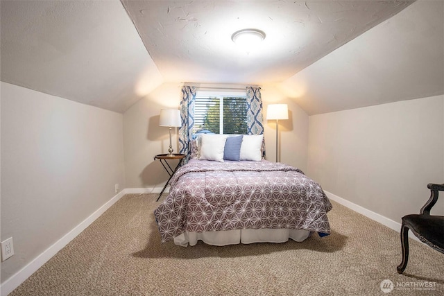 carpeted bedroom featuring baseboards and lofted ceiling