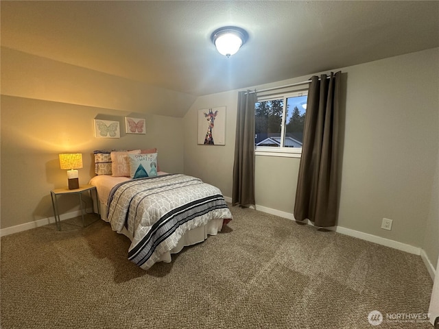 carpeted bedroom with baseboards and lofted ceiling
