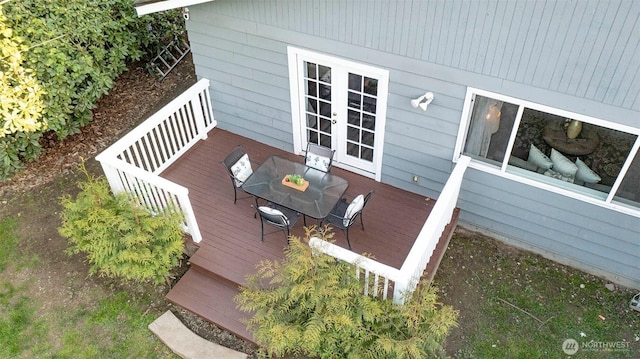 wooden deck with outdoor dining area and french doors