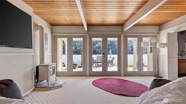 doorway to outside featuring french doors, carpet, and wooden ceiling
