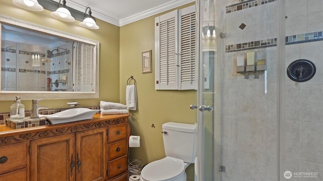 bathroom with crown molding, toilet, vanity, and a stall shower