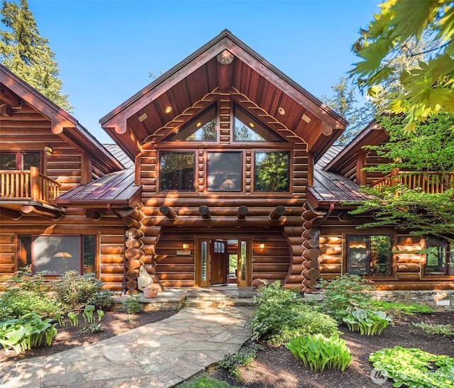log cabin featuring log siding and metal roof