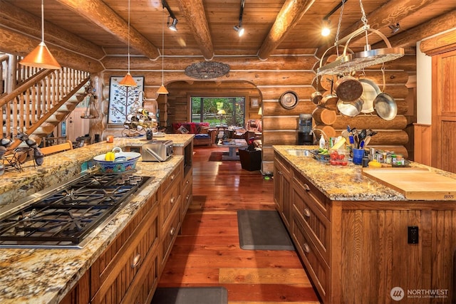 kitchen featuring rustic walls, brown cabinetry, and dark wood-type flooring