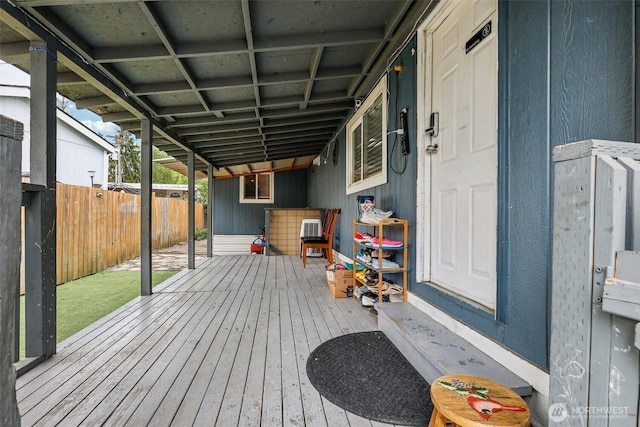 wooden deck with a fenced backyard