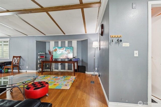 recreation room with baseboards and wood finished floors