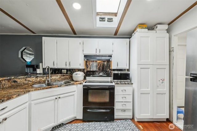 kitchen featuring electric stove, a sink, under cabinet range hood, and white cabinets