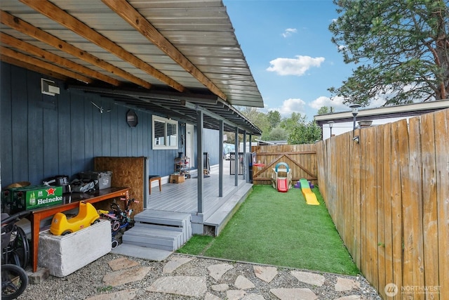 exterior space featuring a wooden deck and a fenced backyard