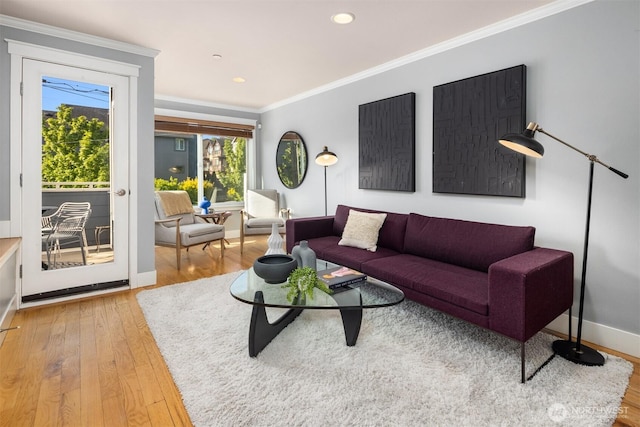 living area featuring wood finished floors, baseboards, ornamental molding, and recessed lighting