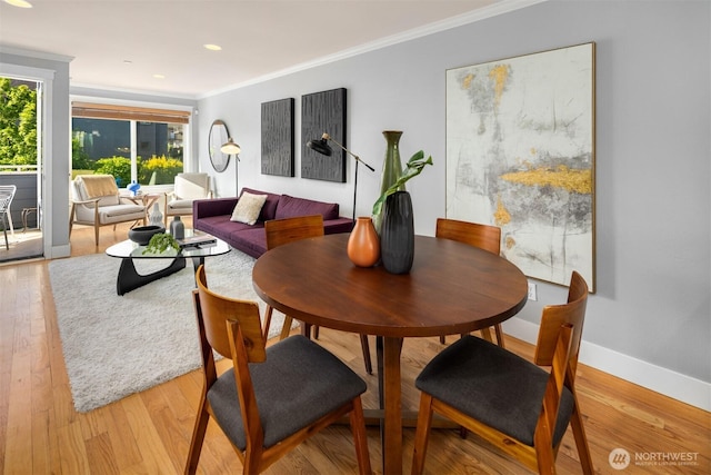 dining space with baseboards, ornamental molding, light wood-style flooring, and recessed lighting