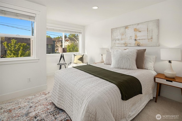 bedroom with baseboards, multiple windows, and carpet flooring