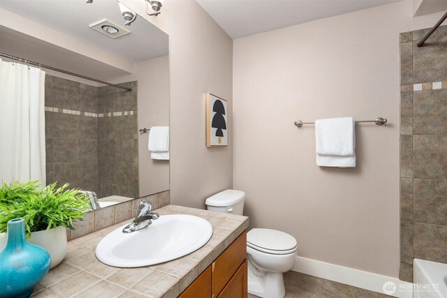 bathroom featuring toilet, a shower with shower curtain, and vanity