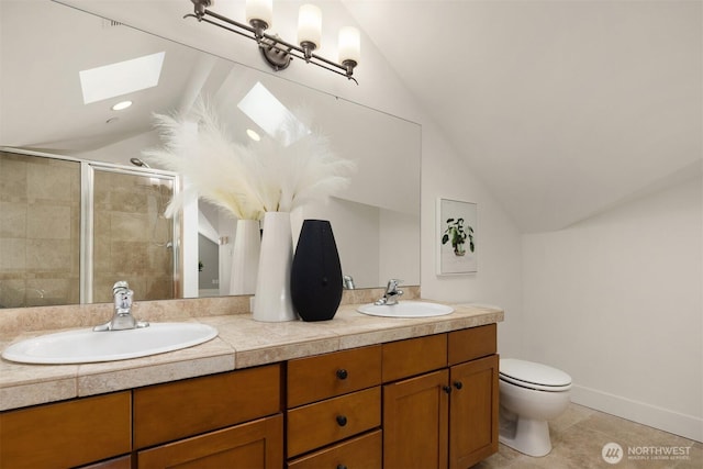 full bath featuring a sink, toilet, a stall shower, and vaulted ceiling with skylight