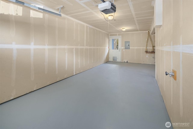garage with a garage door opener and electric panel