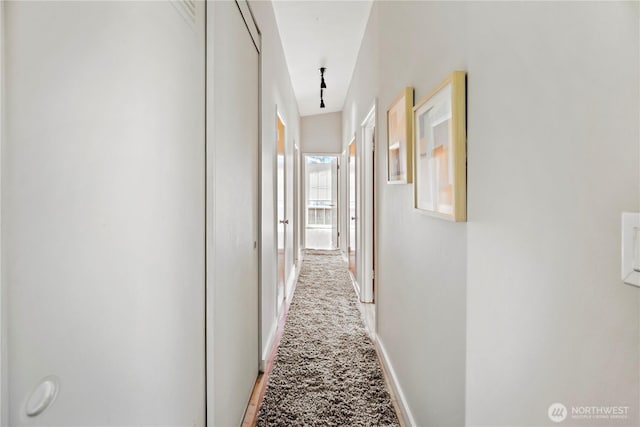 hallway featuring baseboards