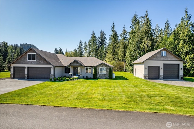 view of front facade featuring an outdoor structure, a front yard, and stone siding
