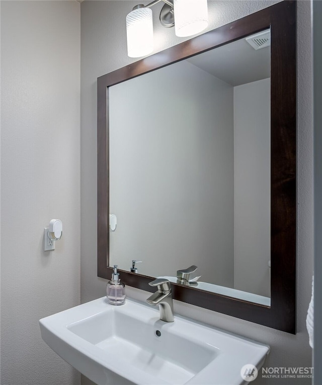 bathroom with visible vents and a sink