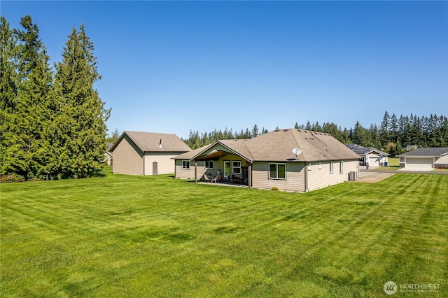 rear view of property featuring a lawn and a patio area