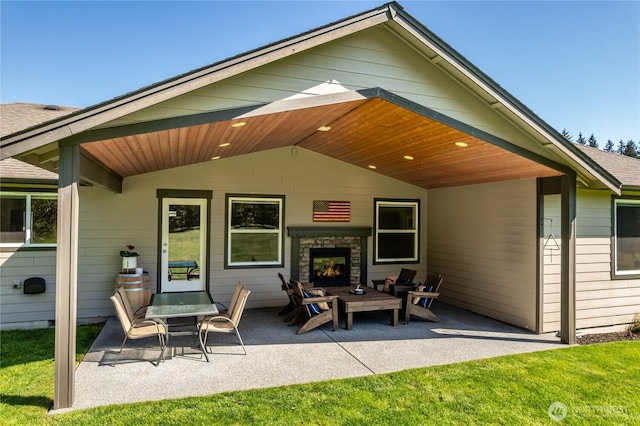 rear view of property with a patio, a yard, and an outdoor brick fireplace