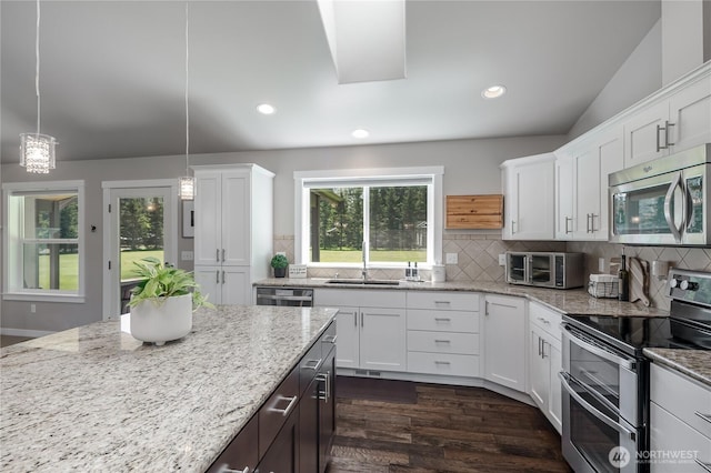 kitchen with a sink, white cabinetry, a toaster, and stainless steel appliances