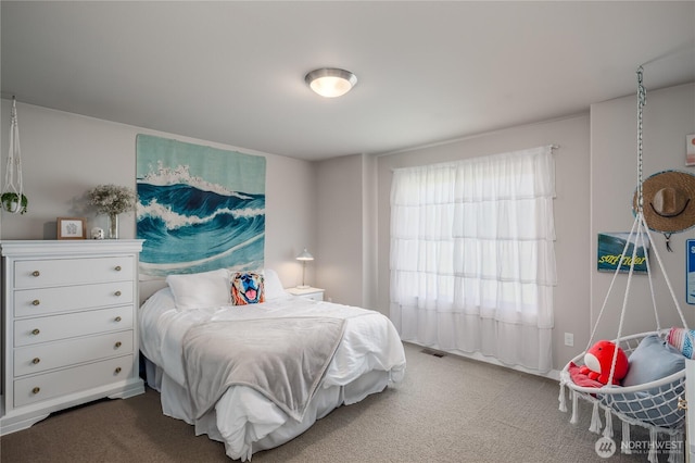 carpeted bedroom featuring visible vents
