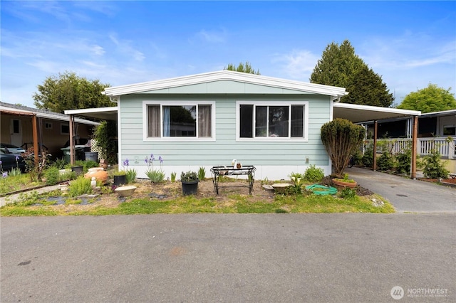 15713 81st St E Unit 135, Puyallup, WA 98372 - manufactured / mobile home featuring driveway and an attached carport