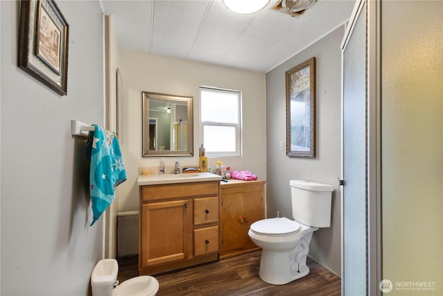 15713 81st St E Unit 135, Puyallup, WA 98372 - bathroom featuring toilet, wood finished floors, and vanity
