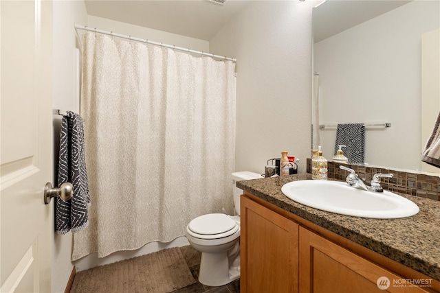 bathroom with toilet, vanity, and a shower with shower curtain