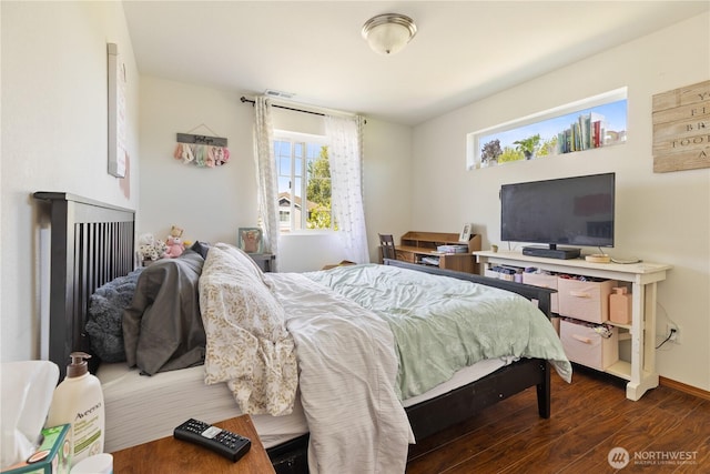 bedroom with wood finished floors and baseboards