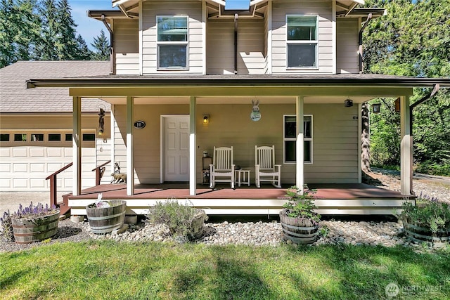view of front of house featuring an attached garage and a porch