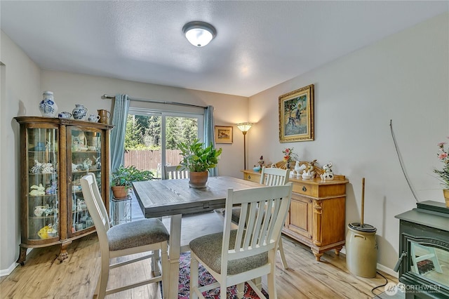 dining area featuring light wood-type flooring and baseboards