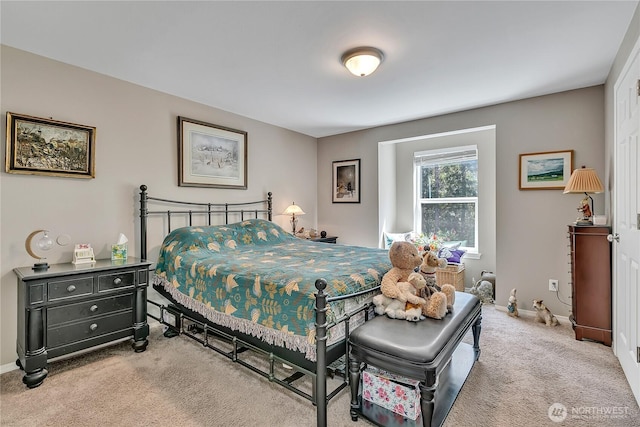 carpeted bedroom featuring baseboards