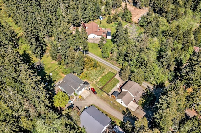 birds eye view of property featuring a wooded view