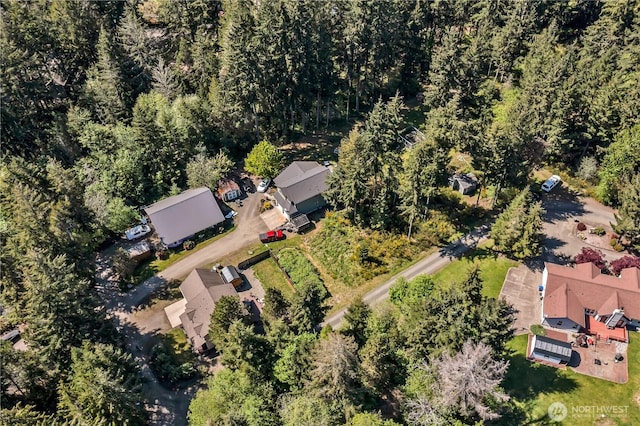 bird's eye view with a wooded view