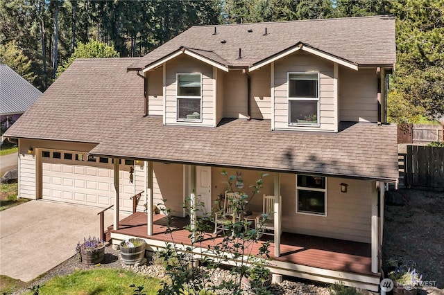 view of front facade featuring a garage, roof with shingles, and driveway