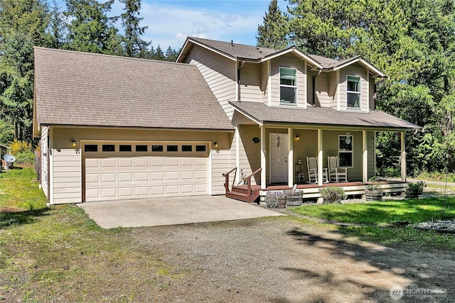 view of front of house with roof with shingles, a garage, dirt driveway, a front yard, and covered porch