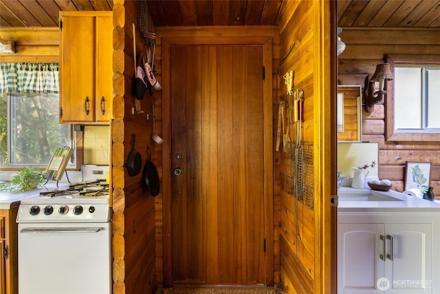 interior space featuring wooden walls, wood ceiling, and laundry area
