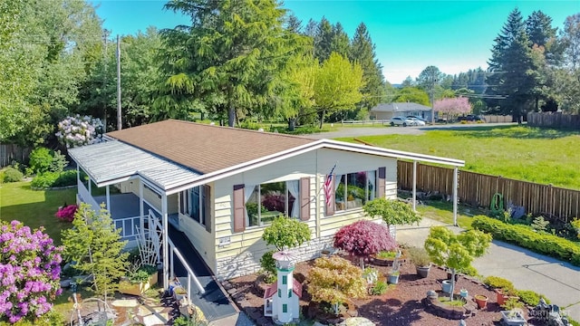 exterior space featuring fence and a front yard