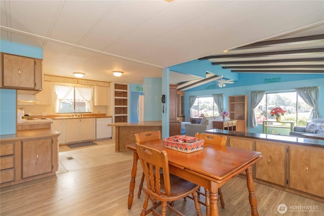 dining space with lofted ceiling with beams and light wood-style floors