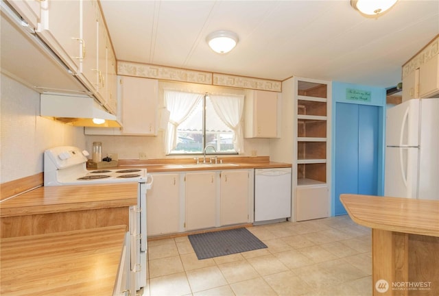 kitchen with a sink, wood counters, white cabinets, white appliances, and light tile patterned flooring