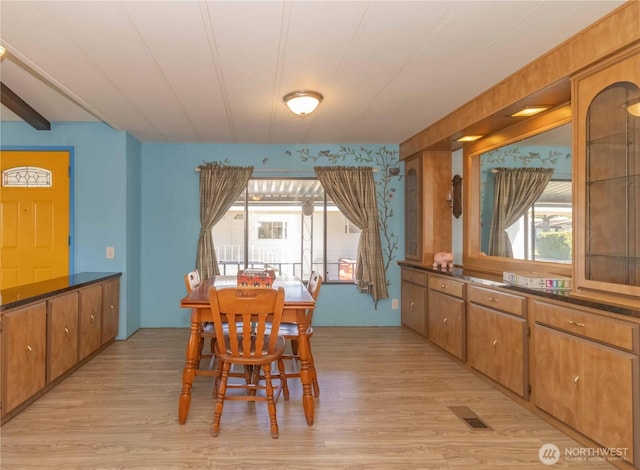 dining space with visible vents and light wood-type flooring