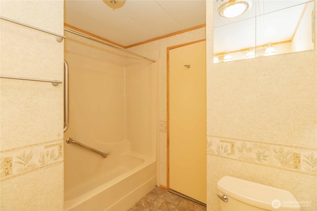 bathroom with crown molding, toilet, and shower / tub combination