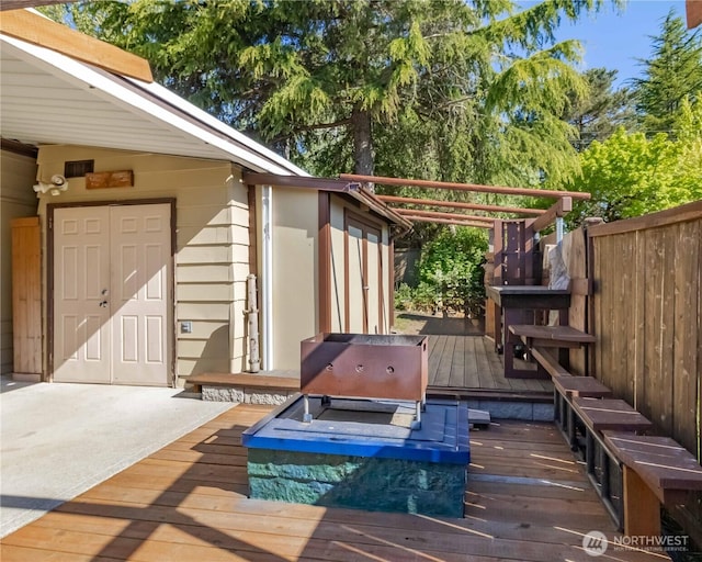 wooden terrace with fence and area for grilling