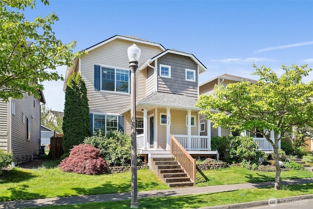 traditional-style house with a porch and a front lawn