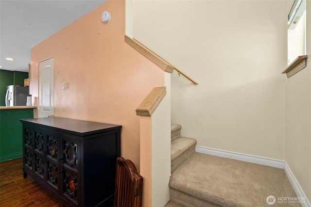 stairway with recessed lighting, baseboards, and wood finished floors