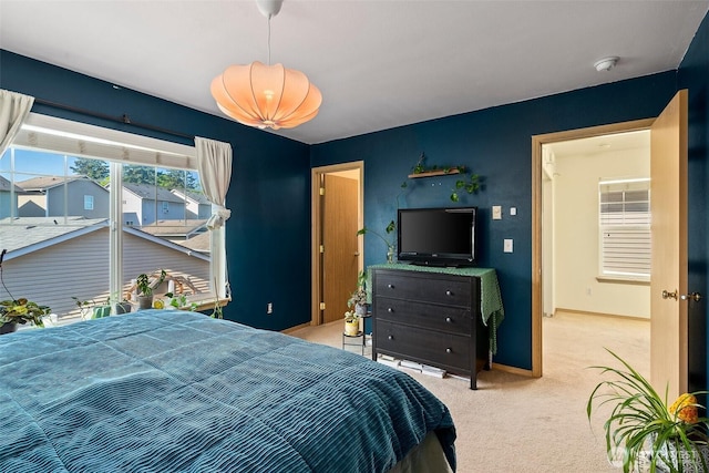 carpeted bedroom with baseboards