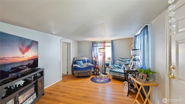 living area with light wood-style floors and baseboards
